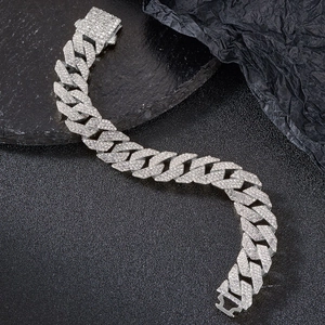 Macro shot of triple-row rhinestone Cuban chain necklace with detailed silver plating
