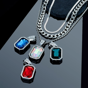 Detailed close-up of large rectangular gemstone pendants with iced-out pave diamonds