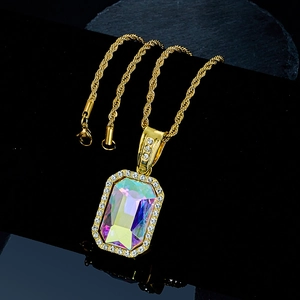 Macro detail of rectangle iridescent gemstone pendant with gold twisted chain and white diamonds