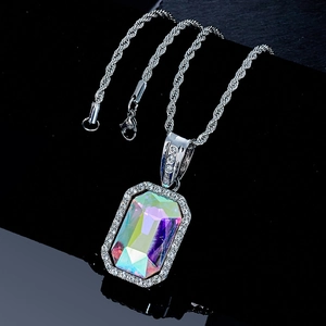 Macro shot of silver hip-hop necklace with rectangular iridescent gemstone and rhinestones