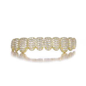 Macro detail of 14k gold plated 10-tooth grillz with shimmering pavé micro-inlays