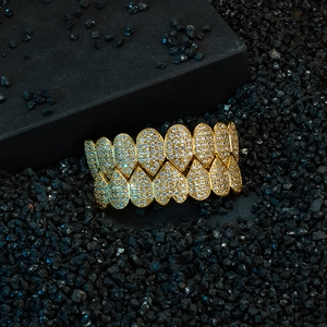 Macro shot of gold double row hip hop grillz with heart shaped pave set zircons