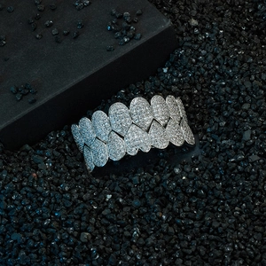 Macro shot of hip hop silver grillz with heart linked design and sparkling cubic zirconia