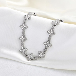 Detailed close-up of 15mm silver-tone hollow clover chain with sparkling pavé crystals