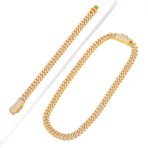 Close-up of gold iced out 12mm Cuban link necklace and bracelet set with box clasp