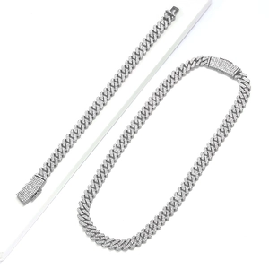 Macro detail of iced out 12mm silver cuban link chain with diamond box clasp closure