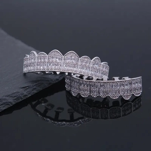 Hip hop silver grillz set with rectangular zircon stones on black mirror background