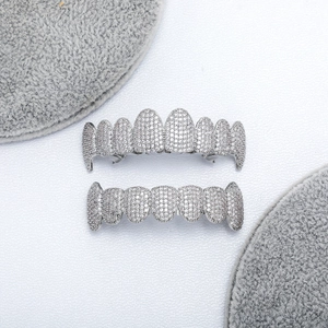 Macro detail of silver-tone hip hop grillz set with sparkling white cubic zirconia stones