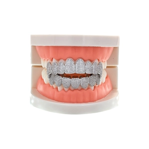 Macro detail of hip hop grillz with silver plating and cubic zirconia on dental model