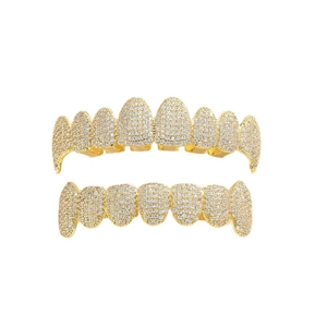 Iced out gold hip hop grillz set with sparkling zircon stones on a white background