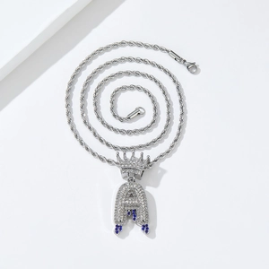 Macro shot of silver hip hop crown letter A pendant with sparkling blue and white rhinestones