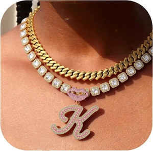 Layered gold Cuban and tennis chain necklace with pink rhinestone lips and letter K pendant