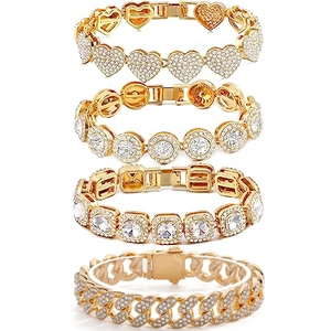 Detail view of four gold-plated Cuban link bracelets with iced-out heart and square charms