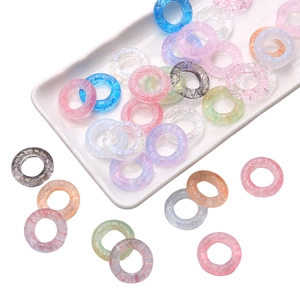 Macro detail of 25mm swirl patterned resin connector loops in assorted macaron colors