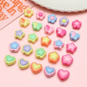 Close-up of matte macaron butterfly and star acrylic beads for DIY jewelry making