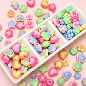 Macro shot of colorful acrylic macaron beads in heart and flower shapes for DIY jewelry