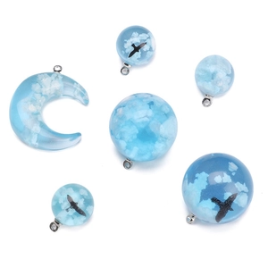 Handmade resin moon and sphere pendants with cloud and bird motifs for DIY jewelry craft