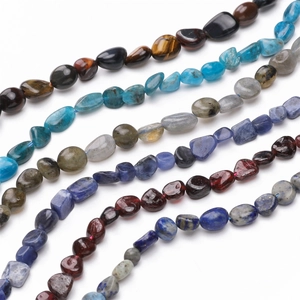 Detailed macro view of assorted irregular natural stone beads for DIY jewelry making