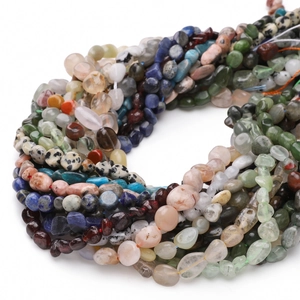 Macro shot of assorted irregular natural stone beads like lapis and agate for DIY jewelry