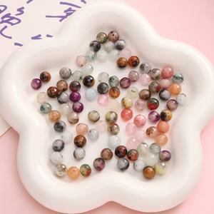 Mix of colorful natural stone faceted round beads in white flower tray for DIY jewelry