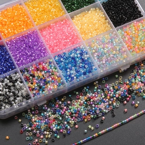 Colorful 2mm glass seed beads set in a transparent storage organizer box for DIY jewelry