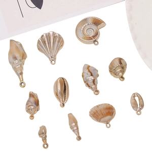 Detailed collection of assorted gold-edged shell and conch pendants for DIY jewelry making