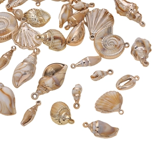 Detail of assorted golden acrylic shell pendants for DIY jewelry crafting projects