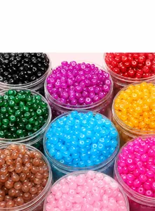 Macro shot of 8x5mm colorful glass abacus beads organized in round containers for DIY