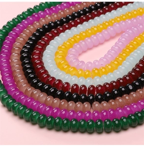 Macro shot of colorful 8x5mm glass abacus beads arranged in neat circular arcs