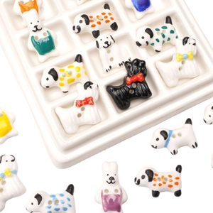 Detailed view of handmade ceramic dog and rabbit charms for DIY jewelry and clothing