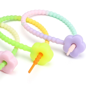 Macro detail of macaron colored silicone teething chain with flower shaped clasp