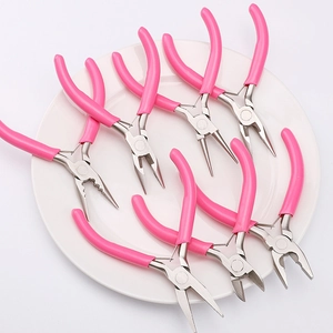 Pink handle jewelry tool set with needle nose and round nose pliers on ceramic plate