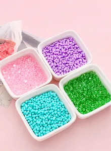 Pastel acrylic peanut beads in colorful ceramic dishes for DIY jewelry crafting and necklaces