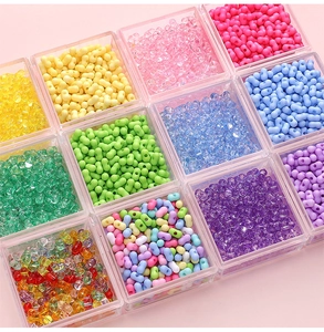 Detailed view of colorful 3x6mm peanut acrylic beads in a 12-grid storage container