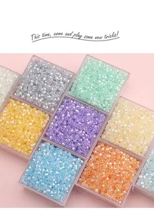 Detailed view of faceted glass beads in various colors stored in a grid organizer box