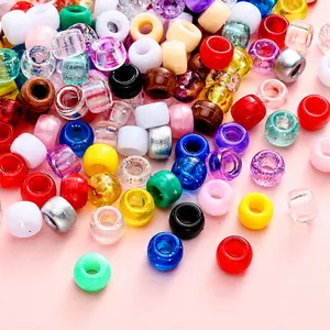 Close-up of assorted colorful acrylic barrel beads with large holes for DIY jewelry making