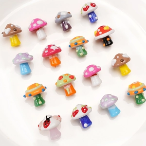 Macro view of colorful hand-painted glass mushroom beads for DIY jewelry making