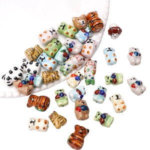 Detailed view of hand-painted ceramic animal beads featuring cats and pandas for DIY crafts