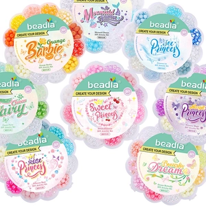 Flat lay of eight colorful DIY bead kits in flower-shaped boxes for jewelry making