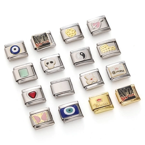 Macro view of stainless steel Italian charms with evil eye and heart pattern details