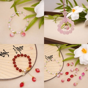 Handmade strawberry and peach glass pendants with beaded bracelets and metallic charms