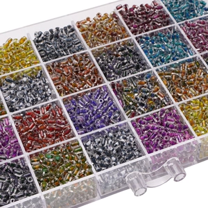Macro shot of colorful 4x5mm glass cylinder beads in a plastic storage box for DIY jewelry