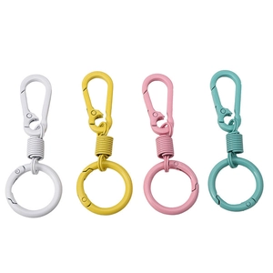 Detailed set of four matte alloy spring hook keychains in white, yellow, pink and green