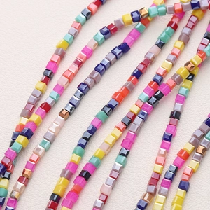 Macro shot of 2mm multi-colored faceted crystal square beads for DIY jewelry making