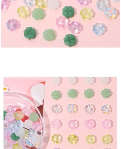 Macro shot of colorful glass four-leaf clover beads for DIY jewelry and necklace crafting