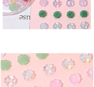 Macro shot of colorful glass four-leaf clover beads for DIY jewelry making and necklace crafts