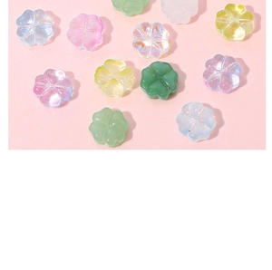 Close-up of colorful four-leaf clover glass beads for DIY jewelry making and crafts