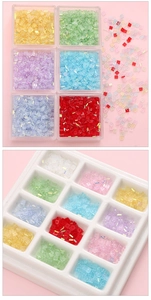 Close-up of colorful square crystal beads in clear boxes and white tray for DIY crafts