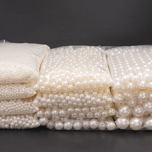 Bulk assortment of white ABS faux pearls in various sizes for DIY jewelry crafting