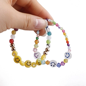 Colorful 10mm smiley face beaded bracelets set with yellow faces and gold heart beads